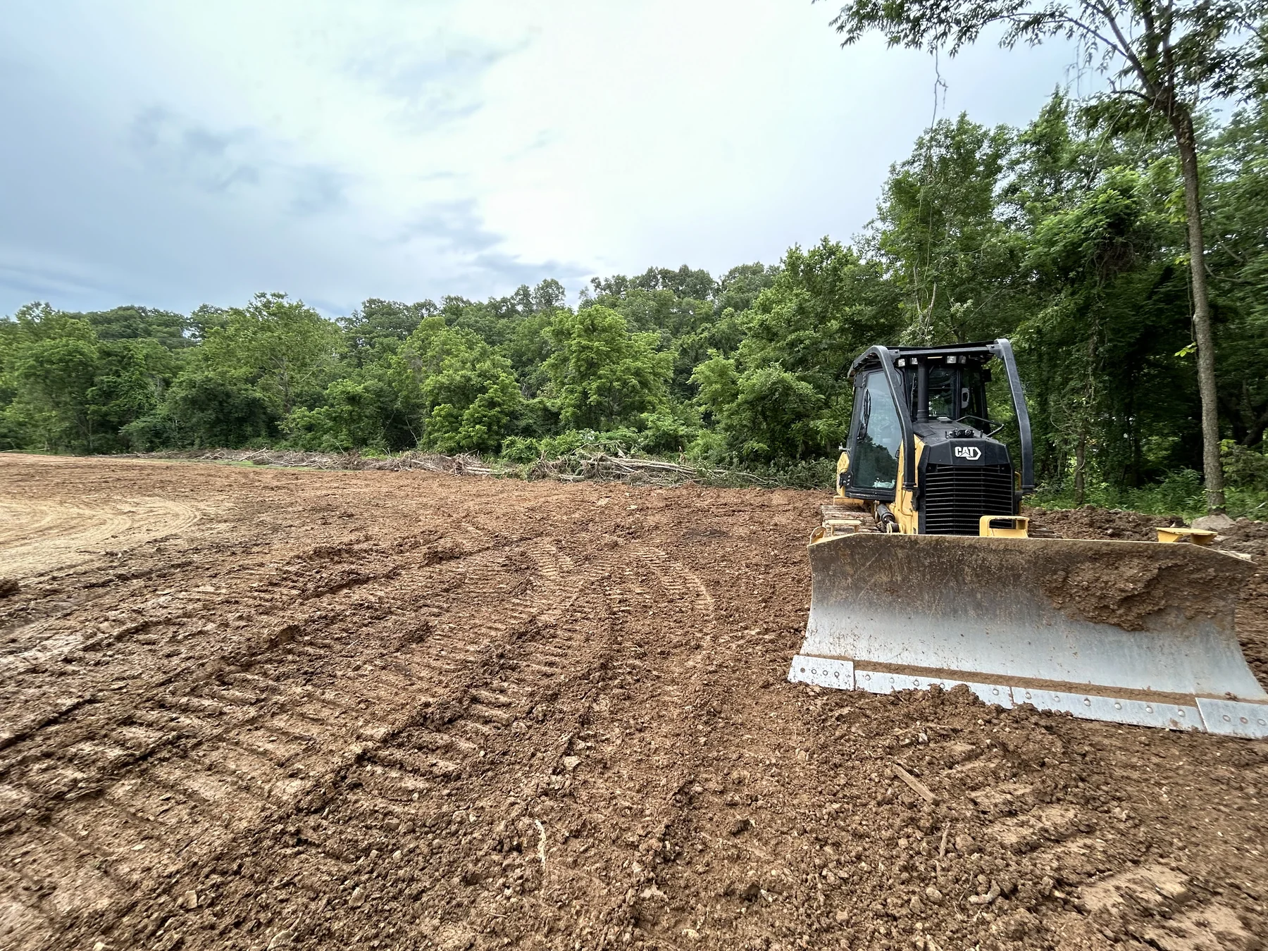 Skid steer grading a prepared work site