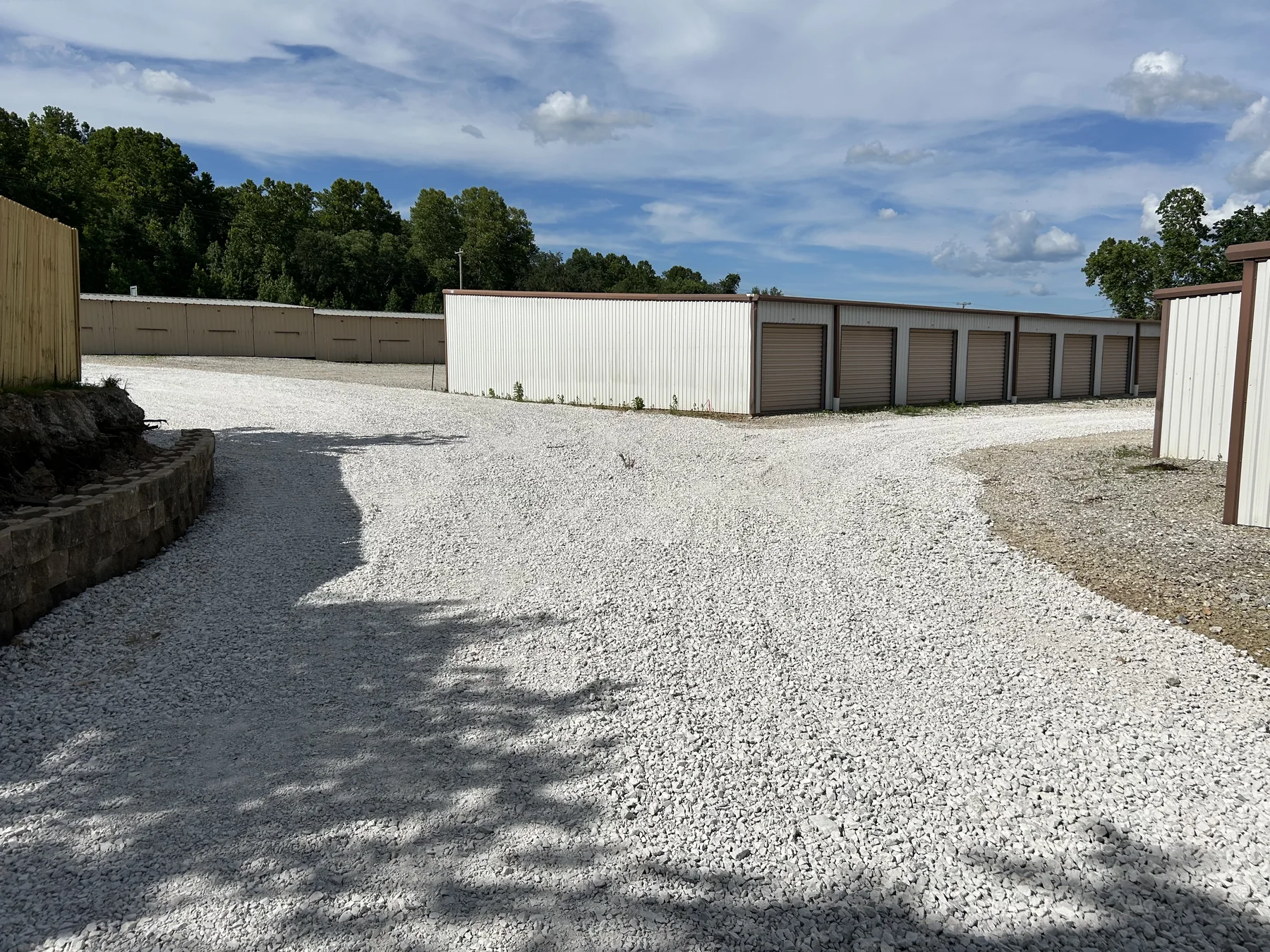 Gravel driveway and finished access near a shop building